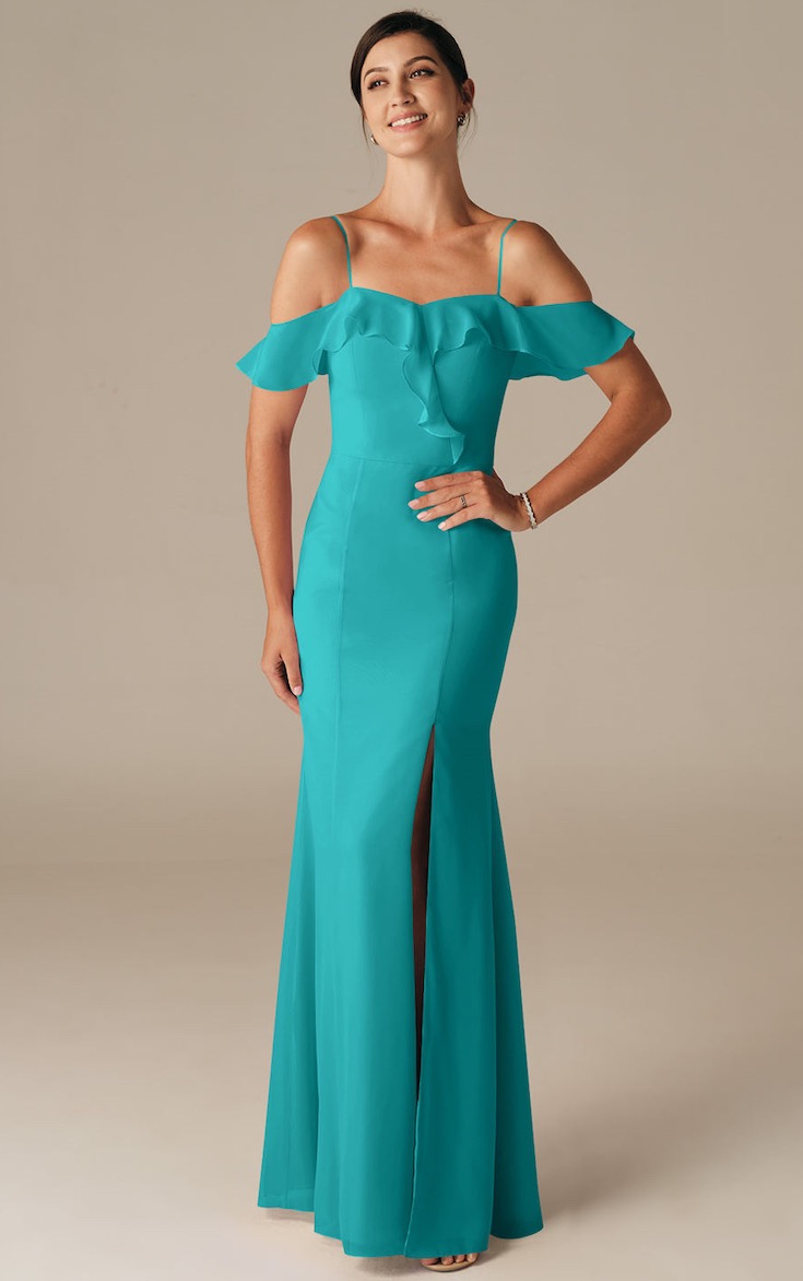 Woman in turquoise trumpet shape gown