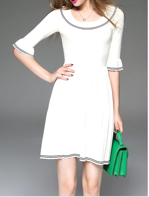White with black piping sweater dress and green purse